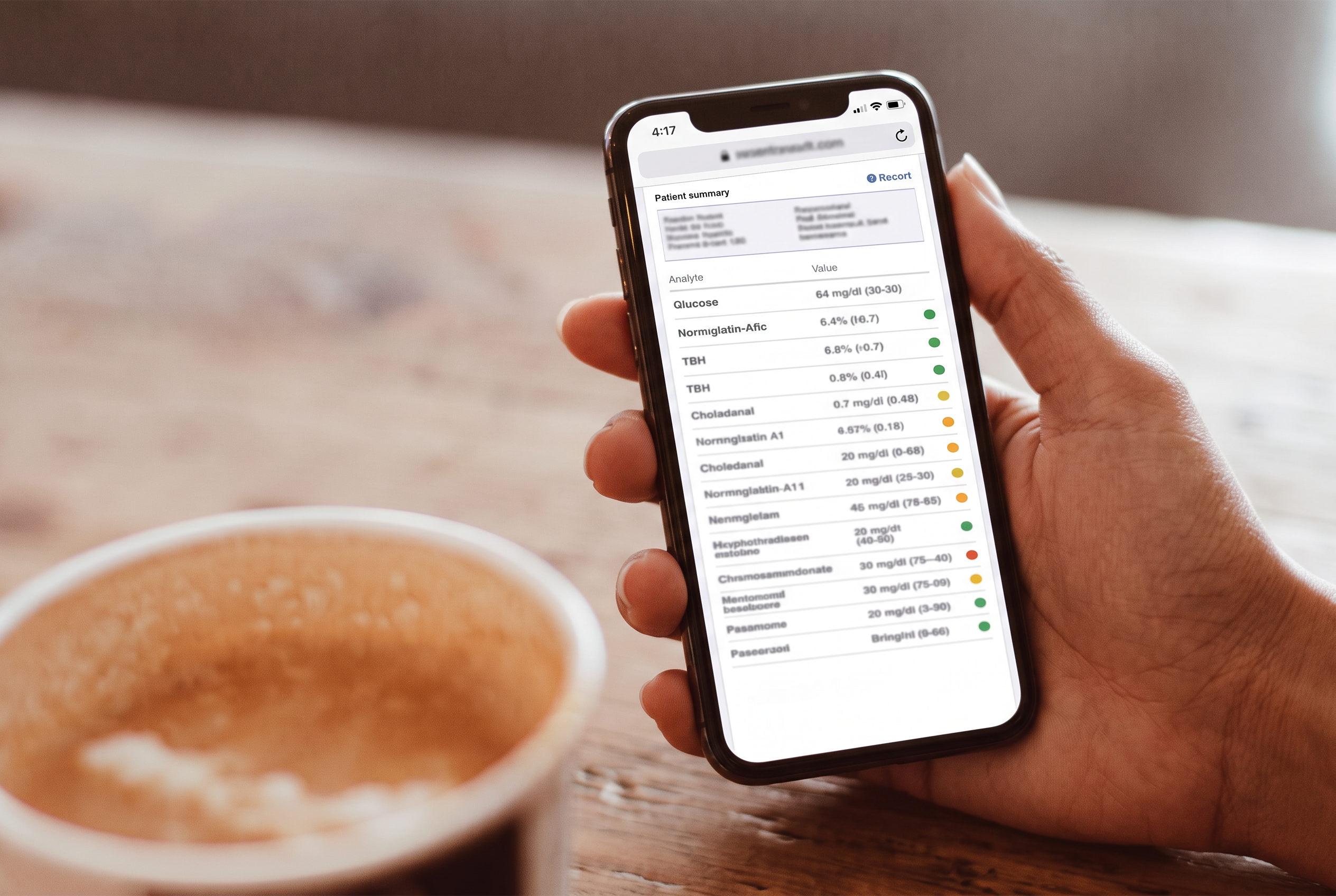 A hand holding a phone upright, showing a lab results report over a wooden table, with a cup of coffee in the foreground